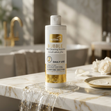 Bottle of 'active X' Bubble Skin Cleaning Solution on a marble surface with a blurred bathroom background.