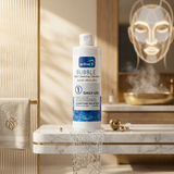Bottle of active X Bubble Skin Cleaning Solution on a bathroom counter with decorative elements.