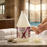 Bottle of ActiveX Callus Remover on a bathroom counter with towels and pebbles in the background.
