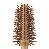 Close-up of natural peach wood hairbrush texture and bristles