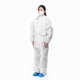 Worker wearing 70 GSM disposable PPE coverall in industrial environment