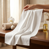 Beauty professional using disposable towels during facial treatment in clean salon environment